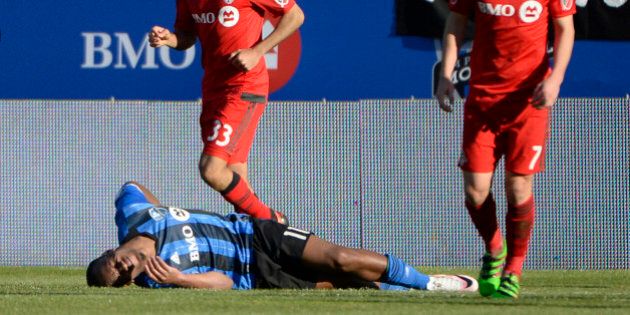 Apr 23, 2016; Montreal, Quebec, CAN; Montreal Impact forward Didier Drogba (11) lays on the ground next to Toronto FC defender Steven Beitashour (33) and Will Johnson (7)during the second half at Stade Saputo. Mandatory Credit: Eric Bolte-USA TODAY Sports