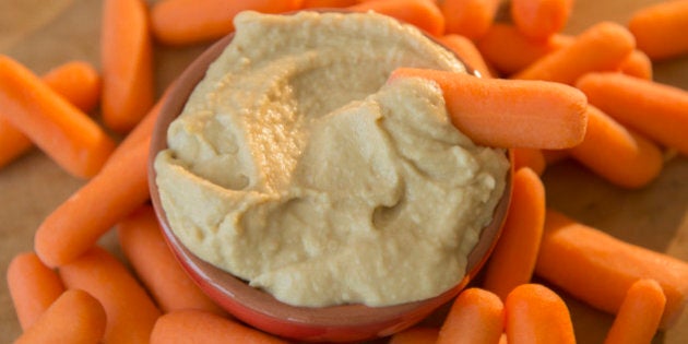 Studio shot of hummus and baby carrots