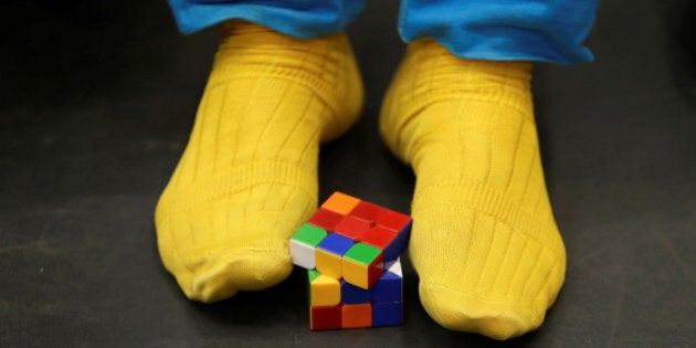 A competitor solves a Rubik's cube using his feet as he prepares for the Rubik's Cube European Championship in Prague, Czech Republic, July 15, 2016. REUTERS/David W Cerny