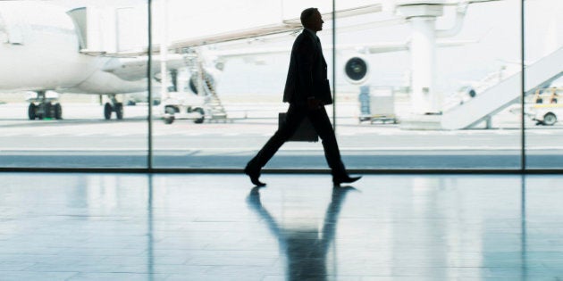 Businessman with suitcase in airport