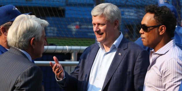 TORONTO, ON- AUGUST 31 - Prime Minister Stephen Harper talks with Toronto Blue Jays manager John Gibbons and Buck Martinez as he walks around batting practice with Robbie Alomar before theToronto Blue Jays play the Cleveland Indians at the Rogers Centre in Toronto. August 31, 2015. (Steve Russell/Toronto Star via Getty Images)
