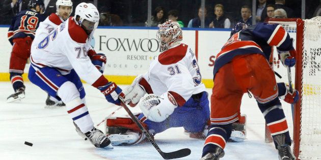 Montreal Canadiens goalie Carey Price (31) blocks a shot attempt by New York Rangers center Oscar Lindberg (24) as Canadiens defenseman P.K. Subban (76) looks for the rebound during the second period of an NHL hockey game Wednesday, Nov. 25, 2015, in New York. (AP Photo/Julie Jacobson)