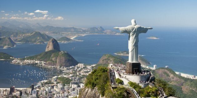 Aerial view of 'Christ The Redeemer' statue with Sugarloaf Mountain, Copacabana Beach and Botafogo Beach in the background.