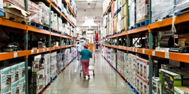 a female shopper walks the aisles of warehouse retailer COSTCO