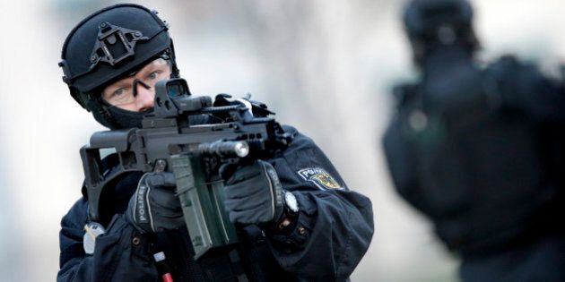 A Police officer holds a weapon during a training operation of the new BFE+ (Evidence and Arrestment) unit of the German federal police in Ahrensfelde near Berlin, Germany, Wednesday, Dec. 16, 2015. Germany on Wednesday introduced the new police unit that officials said will be better armed, outfitted and trained to deal with terrorism, based on an analysis of the countryâs security in the wake of deadly attacks in Paris earlier this year. (AP Photo/Michael Sohn)