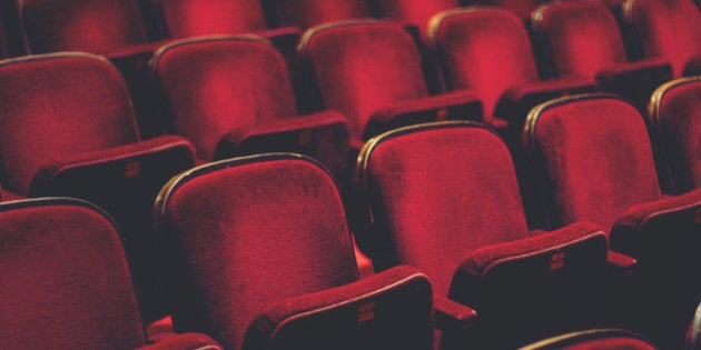 Empty comfortable red seats with numbers in cinema