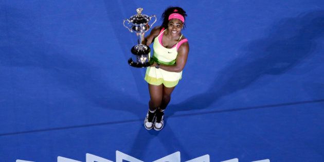 FILE - In this Jan. 31, 2015, file photo, Serena Williams, of the United States, holds the trophy after defeating Maria Sharapova, of Russia, in the women's singles final at the Australian Open tennis championship in Melbourne, Australia. For the fourth time, Williams has been named The Associated Press Female Athlete of the Year. (AP Photo/Lee Jin-man, File)