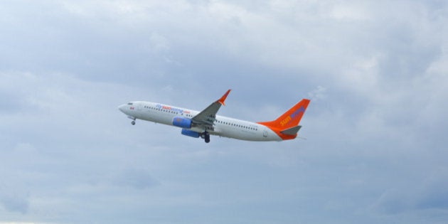 Montreal, Canada- July 3, 2016: Airplane of Sunwing above the Trudeau airport in Canada.