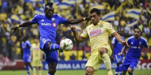 America's Miguel Zamudio (R) from Mexico vies for the ball with Dominic Oduro (L) of Montreal Impact of Canada during their CONCACAF Champions League first leg football final at the Azteca stadium in Mexico City on April 22, 2015. AFP PHOTO/RONALDO SCHEMIDT (Photo credit should read RONALDO SCHEMIDT/AFP/Getty Images)