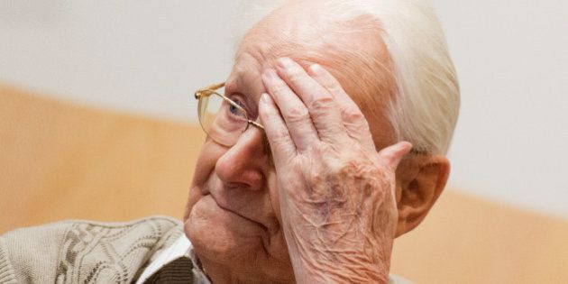 Defendant Oskar Groening sits on the dock of the court in Lueneburg, northern Germany, Tuesday, April 21, 2015. The 93-year-old former Auschwitz guard faces trial on 300,000 counts of accessory to murder, in a case that will test the argument that anyone who served at a Nazi death camp was complicit in what happened there. (Julian Stratenschulte/Pool Photo via AP)