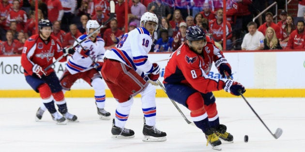 WASHINGTON, DC - MAY 10: Alex Ovechkin #8 of the Washington Capitals moves the puck in front of Marc Staal #18 of the New York Rangers in the third period of the Rangers 4-3 win during Game Six of the Eastern Conference Semifinals during the 2015 NHL Stanley Cup Playoffs at Verizon Center on May 10, 2015 in Washington, DC. (Photo by Rob Carr/Getty Images)