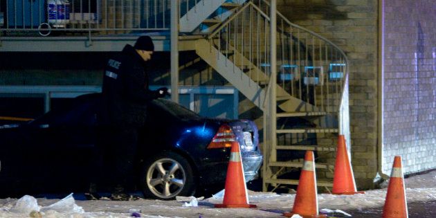 Police search a vehicle near the scene of a murder in the neighbourhood of Notre Dame de Grace, in Montreal, December 28, 2009. Media reports say Nick Rizzuto Jr., the son of Vito Rizzuto, the reputed head of the Montreal mafia, was the victim of a fatal daytime shooting. REUTERS/Christinne Muschi (CANADA - Tags: CRIME LAW)