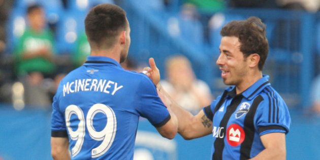 May 14, 2014; Montreal, Quebec, Canada; Montreal Impact forward Jack McInerney (99) celebrates his goal against FC Edmonton with teammate midfielder Hernan Bernardello (23) during the first half at at the Stade Saputo. Mandatory Credit: Jean-Yves Ahern-USA TODAY Sport