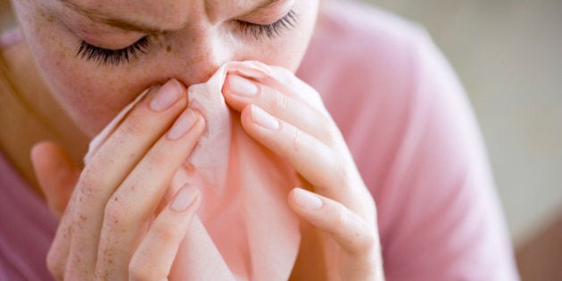 Woman blowing nose