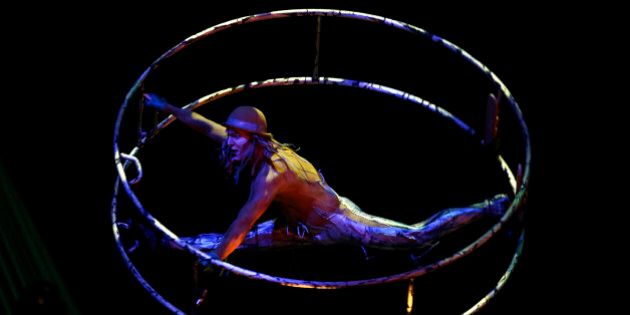 An artist of the Cirque du Soleil performs on the stage during the show