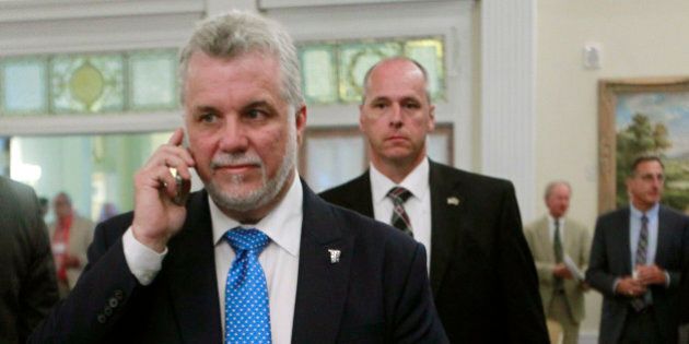 Premier Philippe Couillard of Quebec is seen during a breeak at the New England Governors and eastern Canadian Premiers 38th annual conference Monday, July 14, 2014, in Bretton Woods, N.H. (AP Photo/Jim Cole)