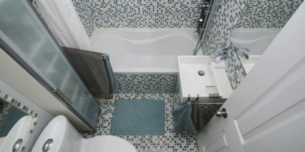 Small, modern bathroom interior. Mosaic tiles. Well organized space. Gray. Blue. White.