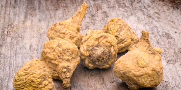 Peruvian ginseng or maca (Lepidium meyenii), dried root on wooden table