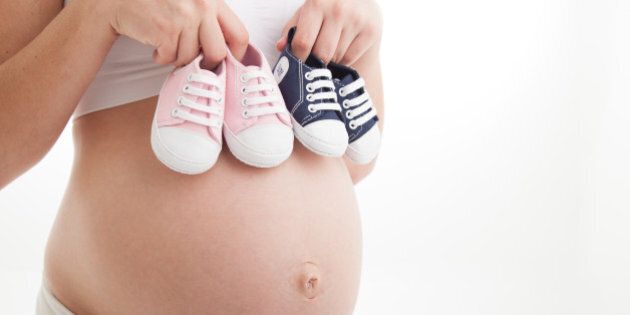 Little navy shoes on pregnant belly
