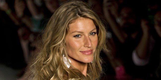 Brazilian supermodel Gisele Bundchen presents a creation by Colcci during the 2015 Summer collections of the Sao Paulo Fashion Week in Sao Paulo, Brazil, on April 2, 2014. AFP PHOTO / Nelson ALMEIDA (Photo credit should read NELSON ALMEIDA/AFP/Getty Images)