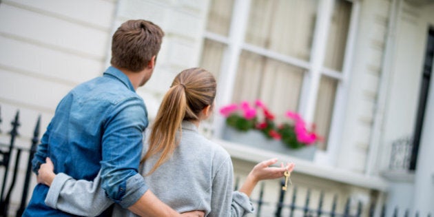 Couple holding keys to their new house