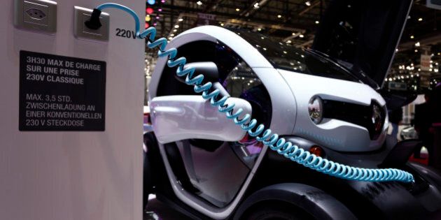 A charging cable leads from a 220V volt household electric plug socket to a Renault Twizy electric automobile, produced by Renault SA, as it stands on display at the company's stand on day two of the 84th Geneva International Motor Show in Geneva, Switzerland, on Wednesday, March 5, 2014. The International Geneva Motor Show runs from Mar. 4, and will showcase the latest models from the world's top automakers. Photographer: Gianluca Colla/Bloomberg via Getty Images