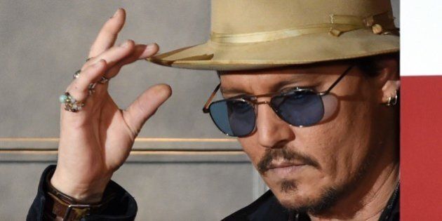US actor Johnny Depp gestures during his photo call in Tokyo on January 28 2015. Depp attended the Japan premiere of his latest action comedy movie 'Mortdecai' on January 27 which will be screened in Japan from February 6. AFP PHOTO / TOSHIFUMI KITAMURA (Photo credit should read TOSHIFUMI KITAMURA/AFP/Getty Images)