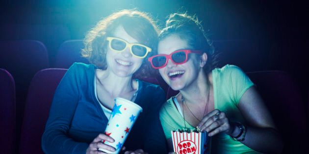 Friends at the cinema wearing 3D glasses