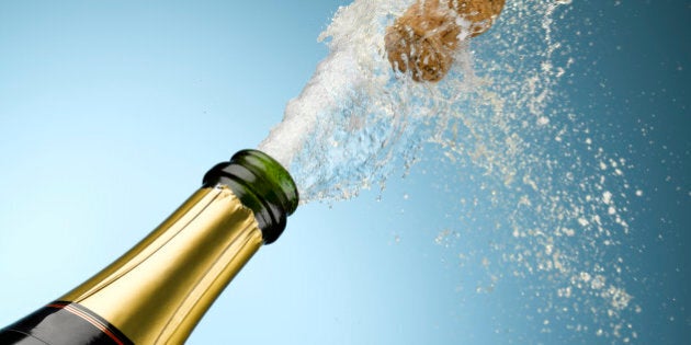 Champagne and cork exploding from bottle