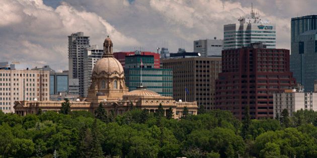 The historic Legislature Building is visible in front of the city.