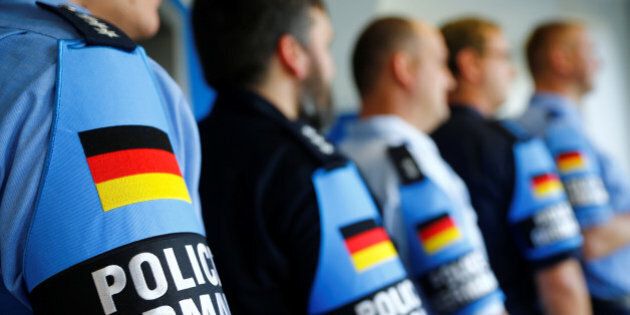 German police officers pose for an image with their armband reading