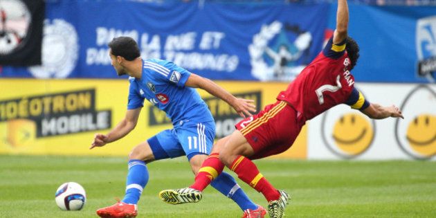 May 16, 2015; Montreal, Quebec, CAN; Real Salt Lake defender Tony Beltran (2) falls after playing for the ball against Montreal Impact midfielder Dilly Duka (11) during the first half at Stade Saputo. Mandatory Credit: Jean-Yves Ahern-USA TODAY Sports