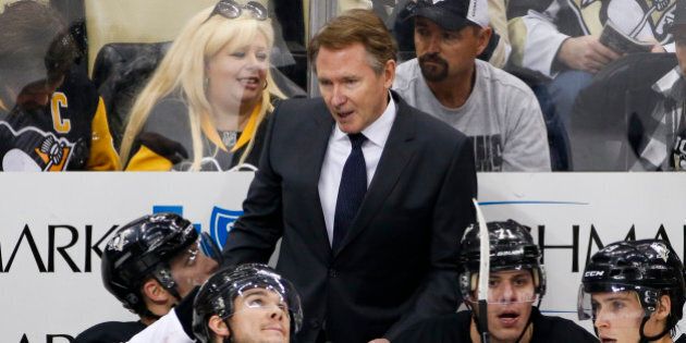 Pittsburgh Penguins' head coach Mike Johnston stands behind his bench during an NHL hockey game against the Los Angeles Kings in Pittsburgh Friday, Dec. 11, 2015. The Kings won 3-2 in a a shootout. (AP Photo/Gene J. Puskar)