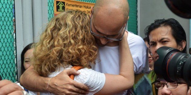 JAKARTA, INDONESIA - AUGUST 14 : Jakarta International School (JIS) teachers Neil Bantleman (R) hugs his wife Tracy Bantleman outside Cipinang prison, shortly after being released from jail, in Jakarta, Indonesia, 14 August 2015. A Canadian teacher and an Indonesian teaching assistant serving 10 years in an Indonesian prison for child sexual offenses were released Friday after a court overturned their convictions. (Photo by Jefri Tarigan /Anadolu Agency/Getty Images)