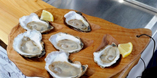 PORTLAND, ME - JULY 31: Brendan Parsons, owner of BP's Shuck Shack, prepared a half dozen oysters in his food cart in front of Custom House on Commercial Street. This is a half dozen Wiley Point Oysters from Mook Sea Farm on the Damariscotta River. Two are cocktail with horseradish, three mignonettes, Classic French, Champaign Tarrigon, and Seaweed Cucumber and one with fresh lemon juice. (Photo by Gordon Chibroski/Portland Press Herald via Getty Images)