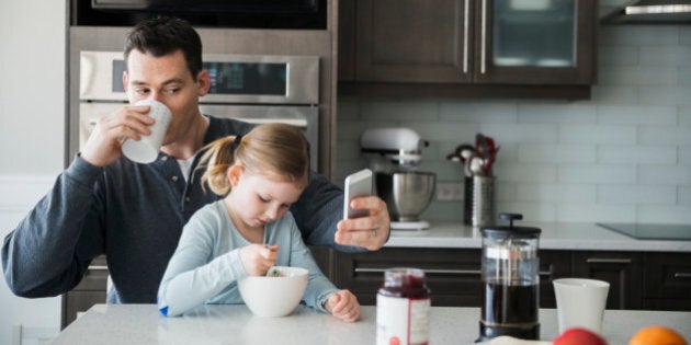 Father and daughter in kitchen in the morning
