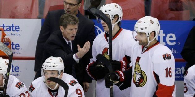 Ottawa Senators assistant coach Mark Reeds talks to left wing Clarke MacArthur (16) during the third period of an NHL hockey game against the Detroit Red Wings in Detroit, Saturday, Nov. 23, 2013. (AP Photo/Carlos Osorio)