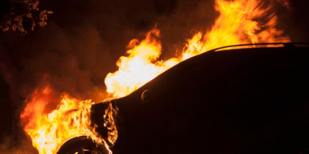 Fire in an automobile engine compartment, and tire burning.