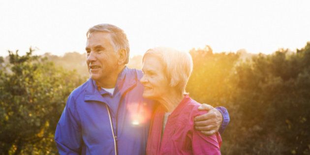Portrait of senior couple in running gear outdoors