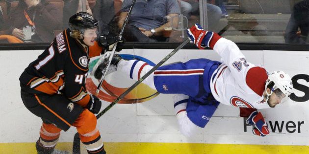 Anaheim Ducks' Hampus Lindholm, left, of Sweden, shoves Montreal Canadiens' Phillip Danault during the third period of an NHL hockey game Wednesday, March 2, 2016, in Anaheim, Calif. The Ducks won 3-2 in a shootout. (AP Photo/Jae C. Hong)