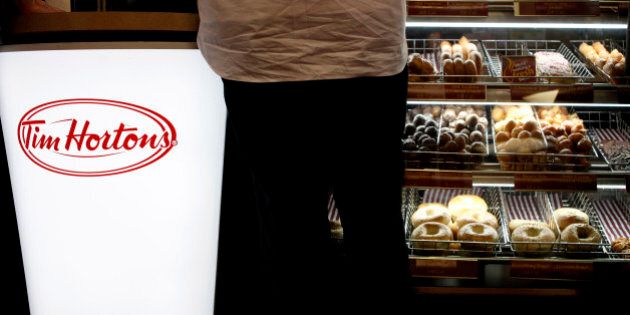 A customer places his order at a Tim Hortons in New York, Wednesday, July 22, 2009. The Canadian doughnut chain moved into 12 former Dunkin Donut locations earlier in the month, bringing new blood to the doughnut war in America's most competitive market. (AP Photo/Seth Wenig)