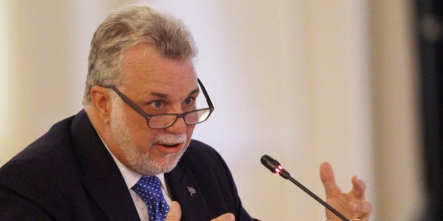 Premier Philippe Couillard of Quebec speaks at the New England Governors and eastern Canadian Premiers 38th annual conference Monday, July 14, 2014, in Bretton Woods, N.H. Energy and economic collaboration were the main topics at Sunday and Monday's conference. Eastern Canada is rich in hydropower while New England markets are eager to shore up supply and control some of the nation's highest energy costs. (AP Photo/Jim Cole)