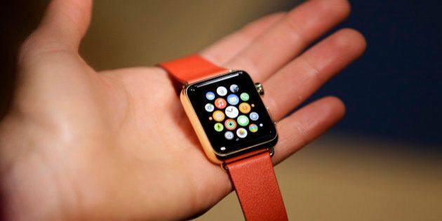 A woman holds the Apple Watch Edition during a demo following an Apple event Monday, March 9, 2015, in San Francisco. Make calls, read email, control music, manage Instagram photos, keep up with your workout, pay for groceries, open your hotel room door. CEO Tim Cook says you can do it all from your wrist with Apple Watch â for 18 hours a day. That's how long the battery will last on an average day. (AP Photo/Eric Risberg)