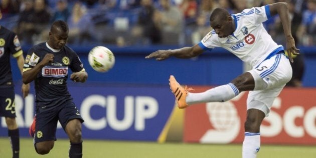 Bakary Soumare (R) of the Montreal Impact clears the ball in front of Club America's Darwin Quintero during the CONCACAF Champions League return leg final in Montreal on April 29, 2015. AFP PHOTO/NICHOLAS KAMM (Photo credit should read NICHOLAS KAMM/AFP/Getty Images)