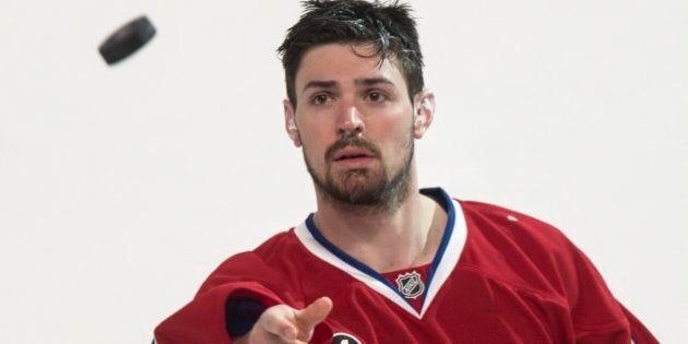 Montreal Canadiens goalie Carey Price tosses a puck to the crowd following their 4-3 victory over the Detroit Red Wings during overtime in NHL hockey action Thursday, April 9, 2015 in Montreal. Price broke a team record with 43 wins for a goaltender. THE CANADIAN PRESS/Paul Chiasson