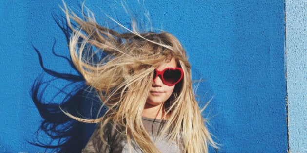 Portrait of a young girl with long hair blowing in the wind