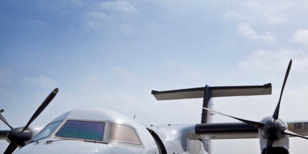 Twin propeller airplane against blue sky