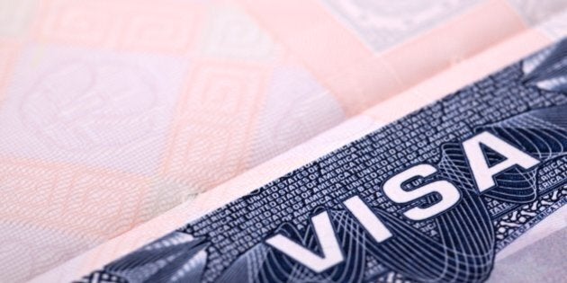 American Visa document inside an open Passport. Extreme close-up with selective focus. Passport page gradually blurred with distance. Space for copy.