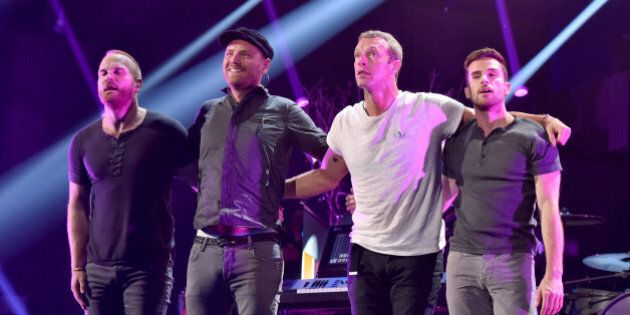 LAS VEGAS, NV - SEPTEMBER 19: (L-R) Recording artists Will Champion, Jonny Buckland, Chris Martin and Guy Berryman of the band Coldplay perform onstage during the 2014 iHeartRadio Music Festival at the MGM Grand Garden Arena on September 19, 2014 in Las Vegas, Nevada. (Photo by Kevin Winter/Getty Images for Clear Channel)