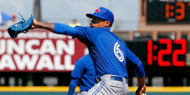 Toronto Blue Jays starting pitcher Marcus Stroman warms up between innings of a spring training exhibition baseball game against the Pittsburgh Pirates in Bradenton, Fla., Wednesday, March 4, 2015. The bottom clock in the outfield counts down from three minutes between each inning. (AP Photo/Gene J. Puskar)